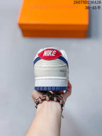 Rear view of a white sneaker with blue outsole detailing and a red heel label.