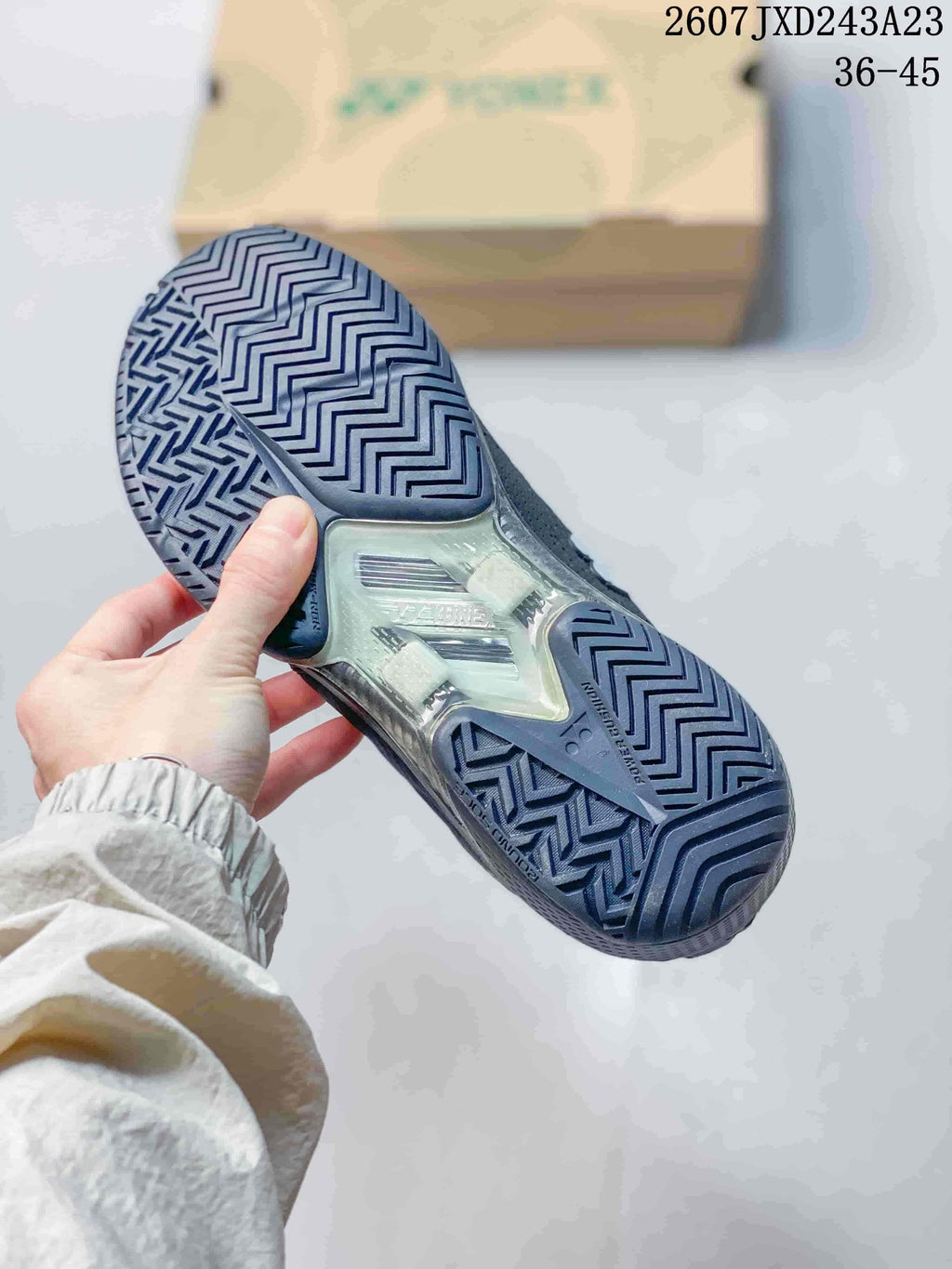 Close view of the Yonex shoe outsole showing a repeating zigzag tread pattern and translucent midfoot section.