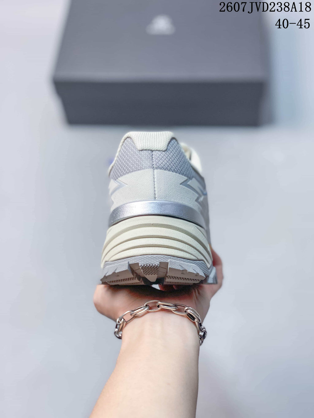 Rear view of the white and blue hiking shoe showing the padded heel and layered outsole.