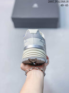 Rear view of the white and blue hiking shoe showing the padded heel and layered outsole.