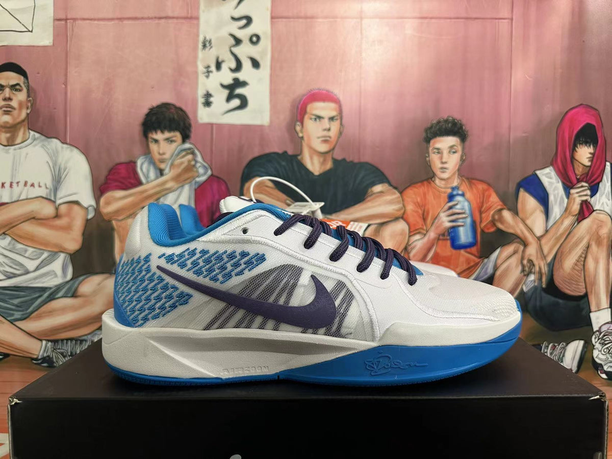 Side profile of a white Nike basketball shoe with blue details, patterned side panels, and a dark swoosh.