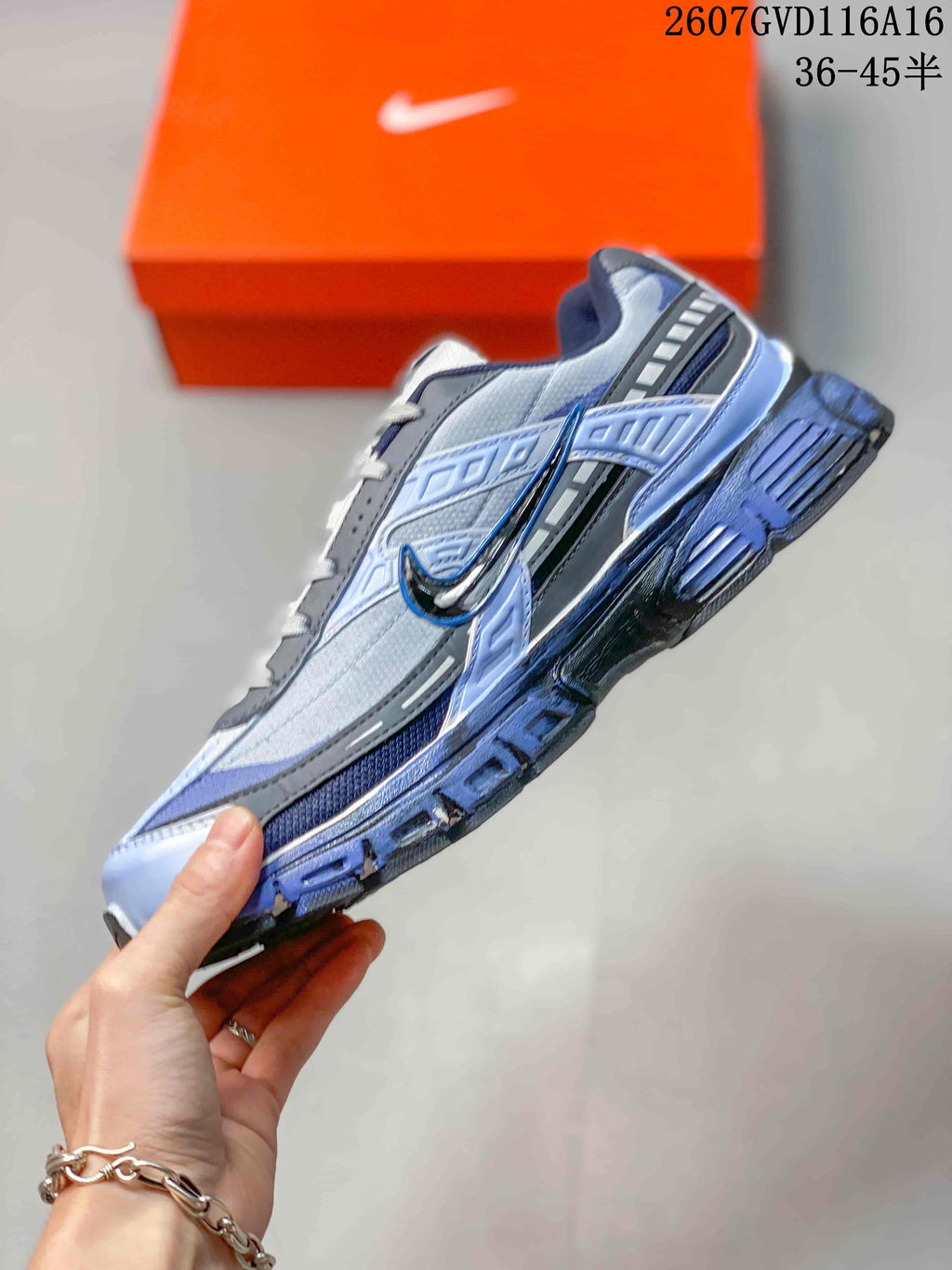 Side profile highlighting the layered panels, side swoosh and thick outsole.