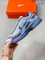 Side profile highlighting the layered panels, side swoosh and thick outsole.