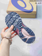 Close view of the patterned rubber outsole showing deep geometric traction grooves on an ASICS sneaker.