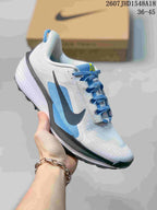 White and blue Nike ReactX Pegasus ACG Trail 6 sneaker shown from a side and front angle.