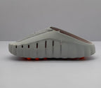 Side view of the gray slide sandal showing ventilation openings along the upper and the raised outsole profile.