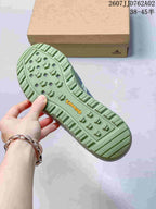Close-up of the green lugged outsole and Terrex branding