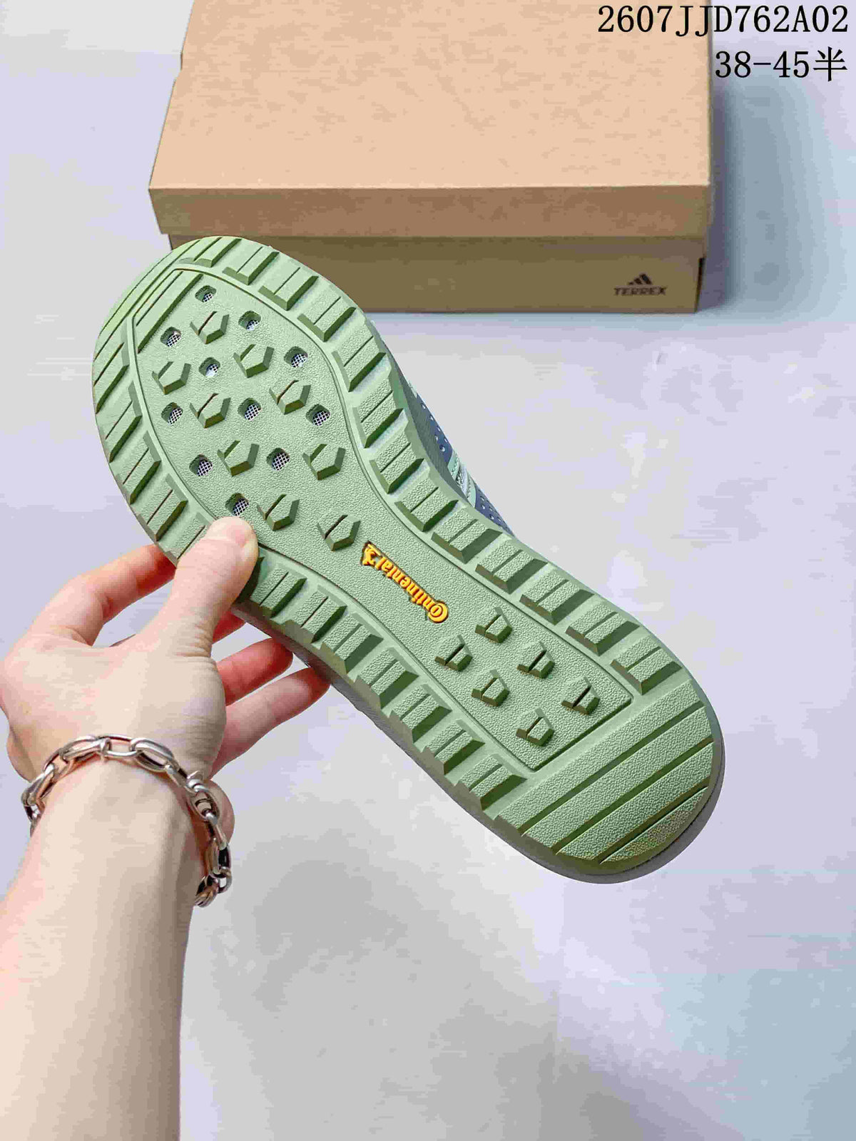 Close-up of the green lugged outsole and Terrex branding