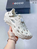 Side view of a white perforated shoe showing its heel strap, cutouts and round lace toggle.