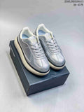 Pair of metallic silver Onitsuka Tiger Delecity low-top sneakers on a box