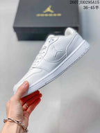 Side view of the white low-top sneaker showing the Jordan side logo, stitched panels and rubber outsole.