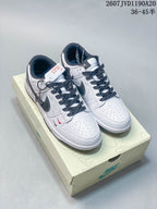 Pair of white and black Nike low-top sneakers displayed on a branded shoe box, with product code and size range text visible above.