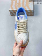 Top view showing the perforated toe box, cream laces, blue collar, and GGDB tongue label.