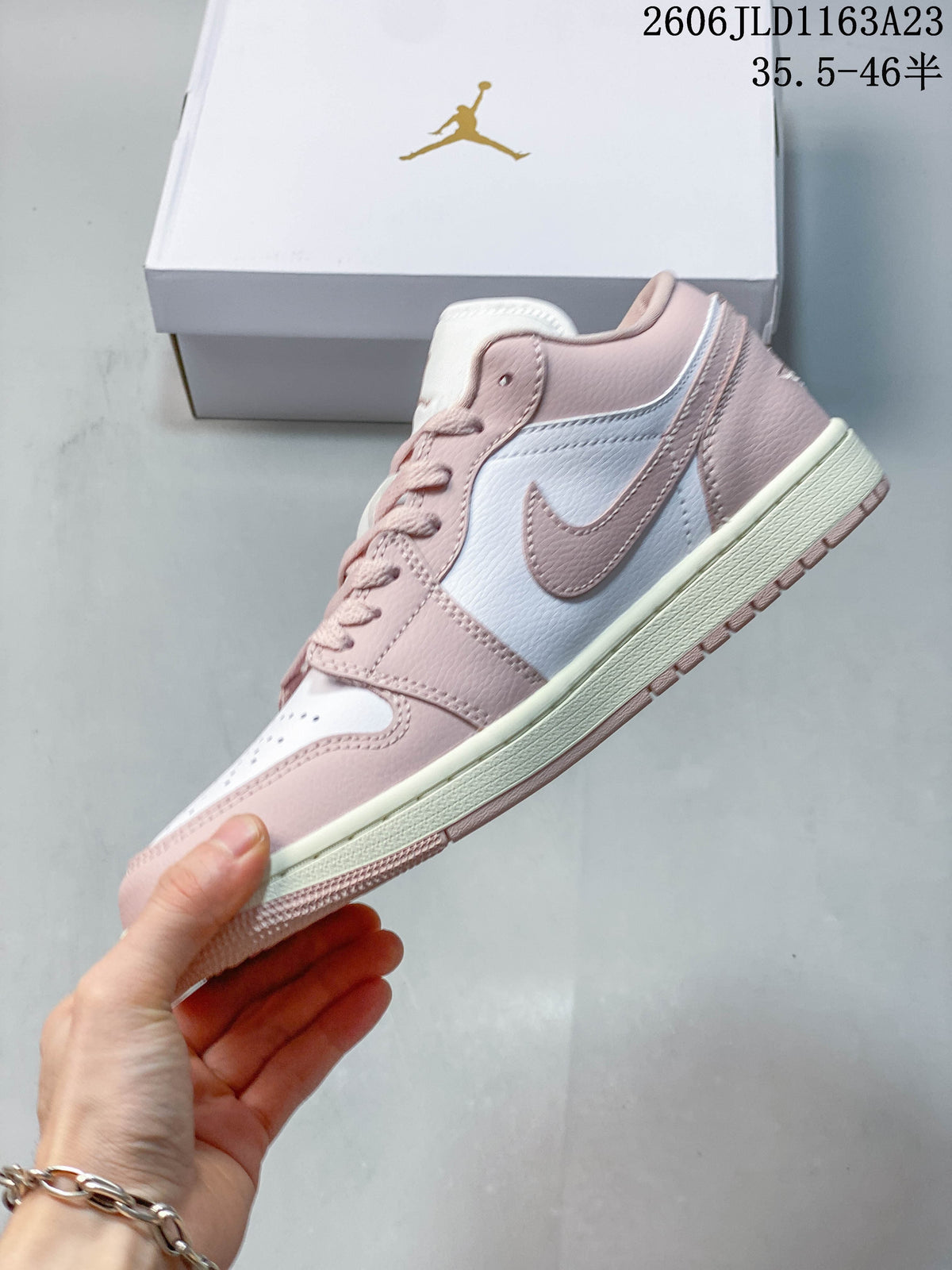 Side view of a pink and white low-top sneaker