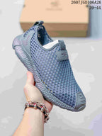 Angled view of a blue-gray SREGIEK sneaker showing the mesh upper, heel branding, pull tabs, and thick sole.