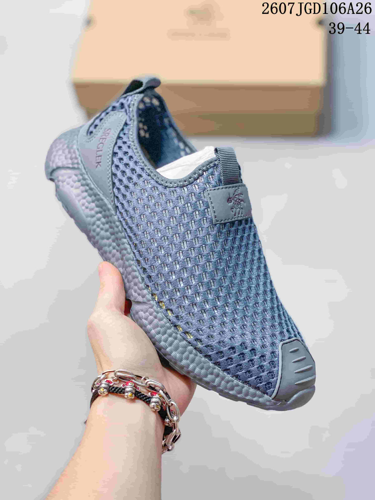 Angled view of a blue-gray SREGIEK sneaker showing the mesh upper, heel branding, pull tabs, and thick sole.