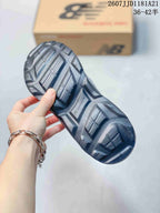 Close view of the dark textured outsole with geometric tread sections.