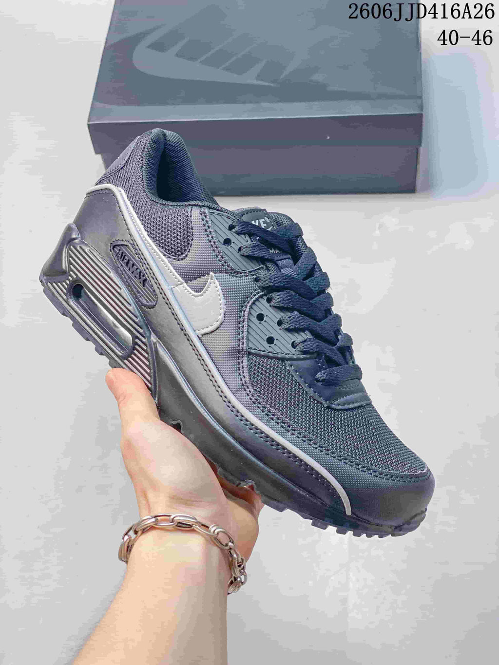 Dark gray Nike Air Max 90 sneaker with white Swoosh detailing