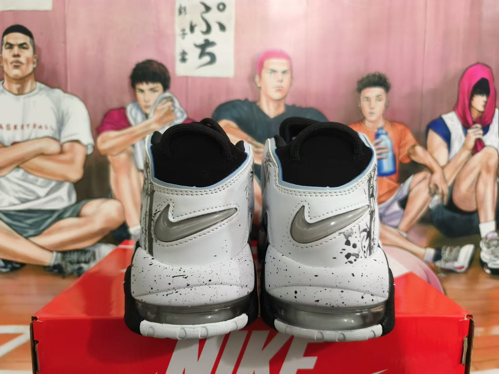 Rear view of black-and-white Nike high-top sneakers with speckled details and gray heel logos.
