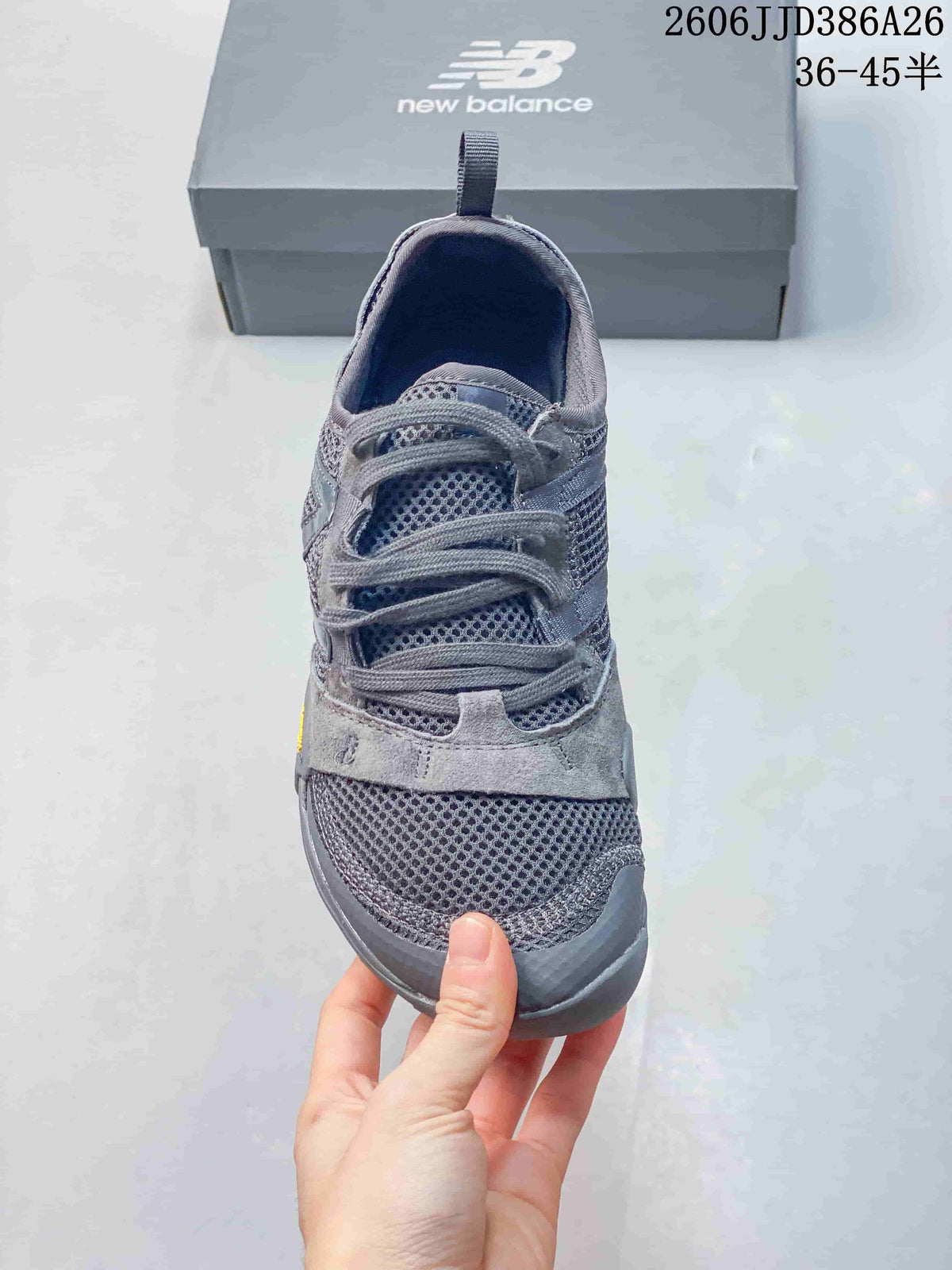 Front view of the grey sneaker showing the mesh toe box, layered overlays, and laces.