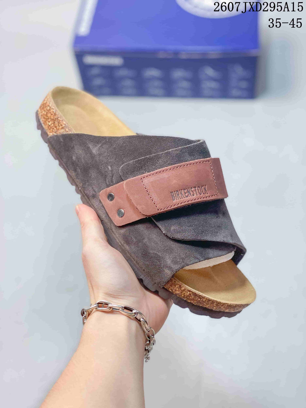 Brown and dark taupe Boston-style clog with an adjustable strap, cork-look footbed edge and textured outsole.