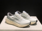 Three-quarter view of the white and light gray Brooks Glycerin 21 pair with cream-colored midsoles.