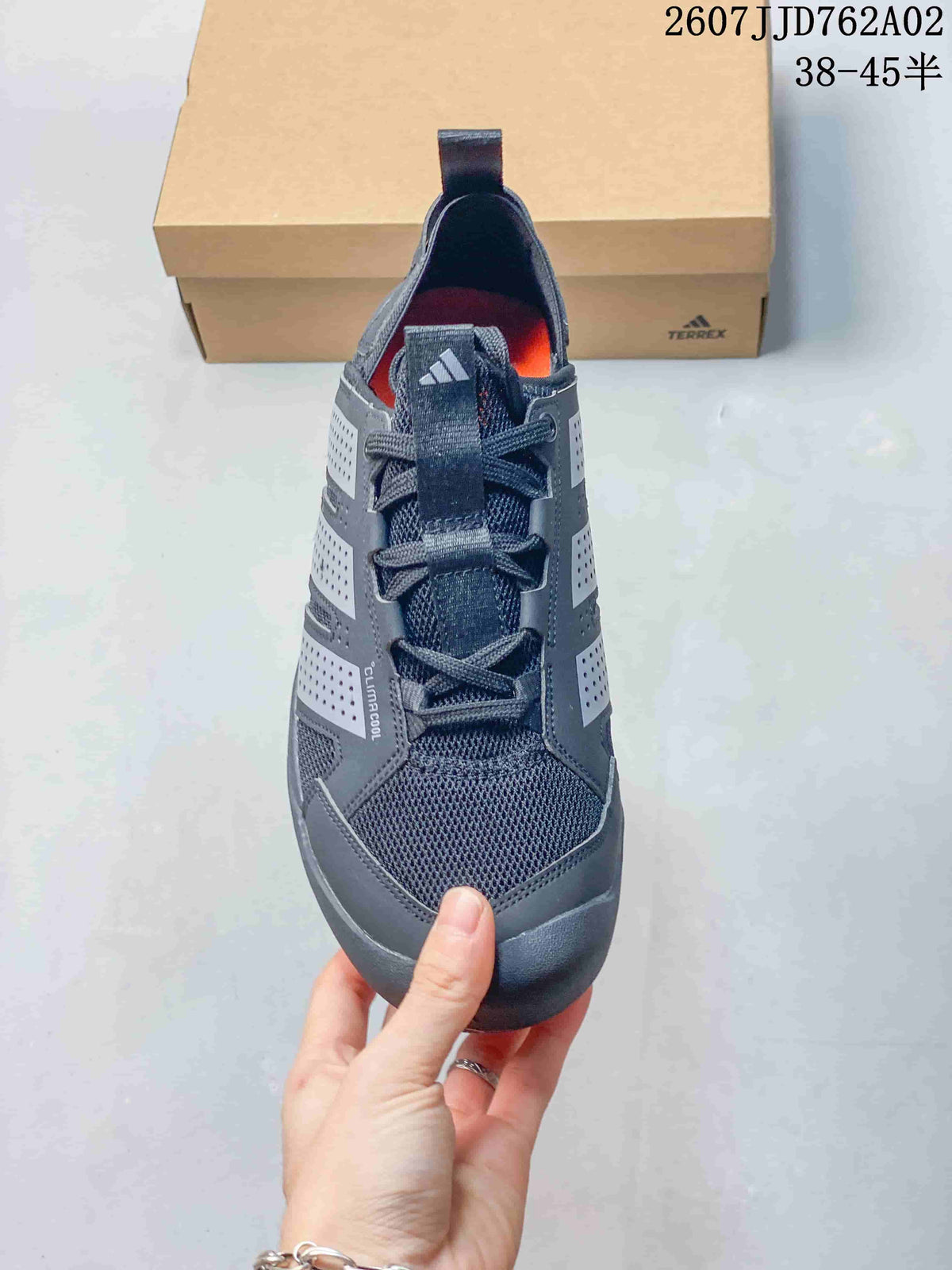 Top view of a charcoal grey lace-up outdoor shoe with mesh panels and orange insole accents.