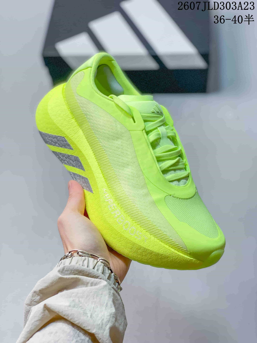 Angled side view showing the neon yellow-green sneaker profile and layered upper panels.