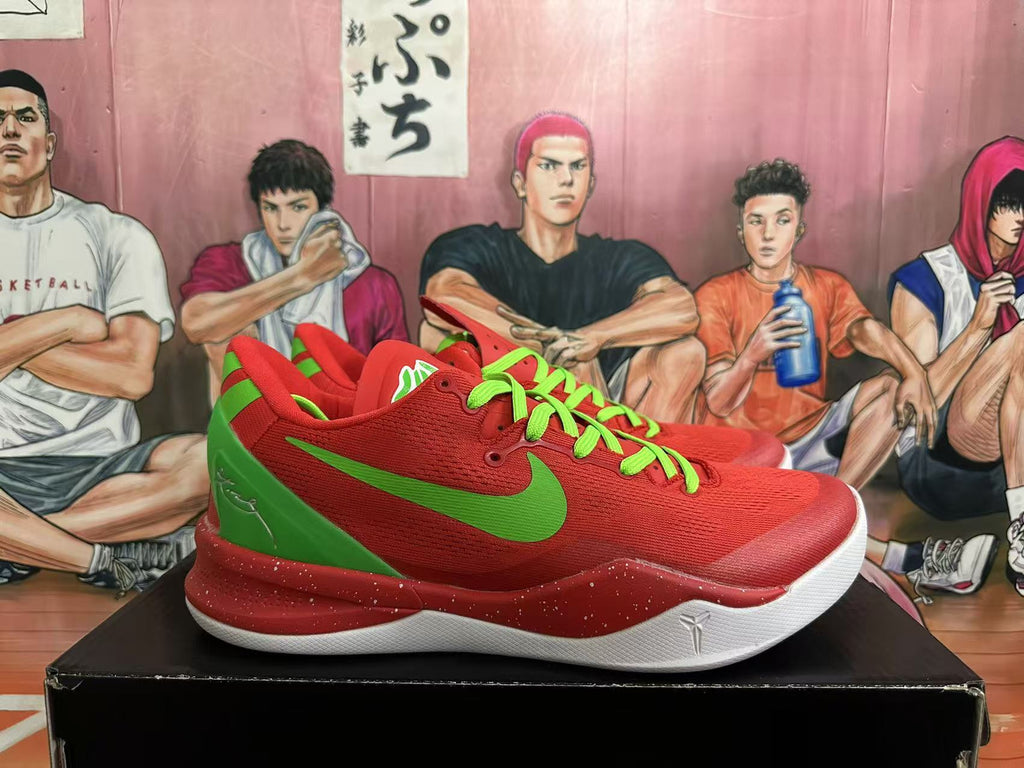Side view of red Nike Kobe basketball shoes with green Swoosh and speckled midsole