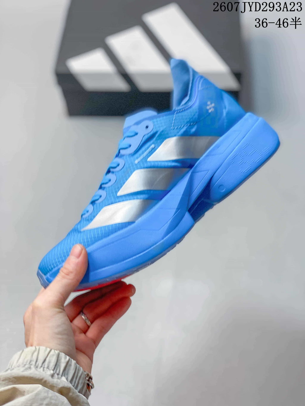 Side profile of the blue sneaker showing silver side panels, red accents and the blue midsole and outsole.
