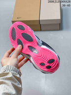 Underside of the sneaker showing a bright pink outsole with dark traction sections