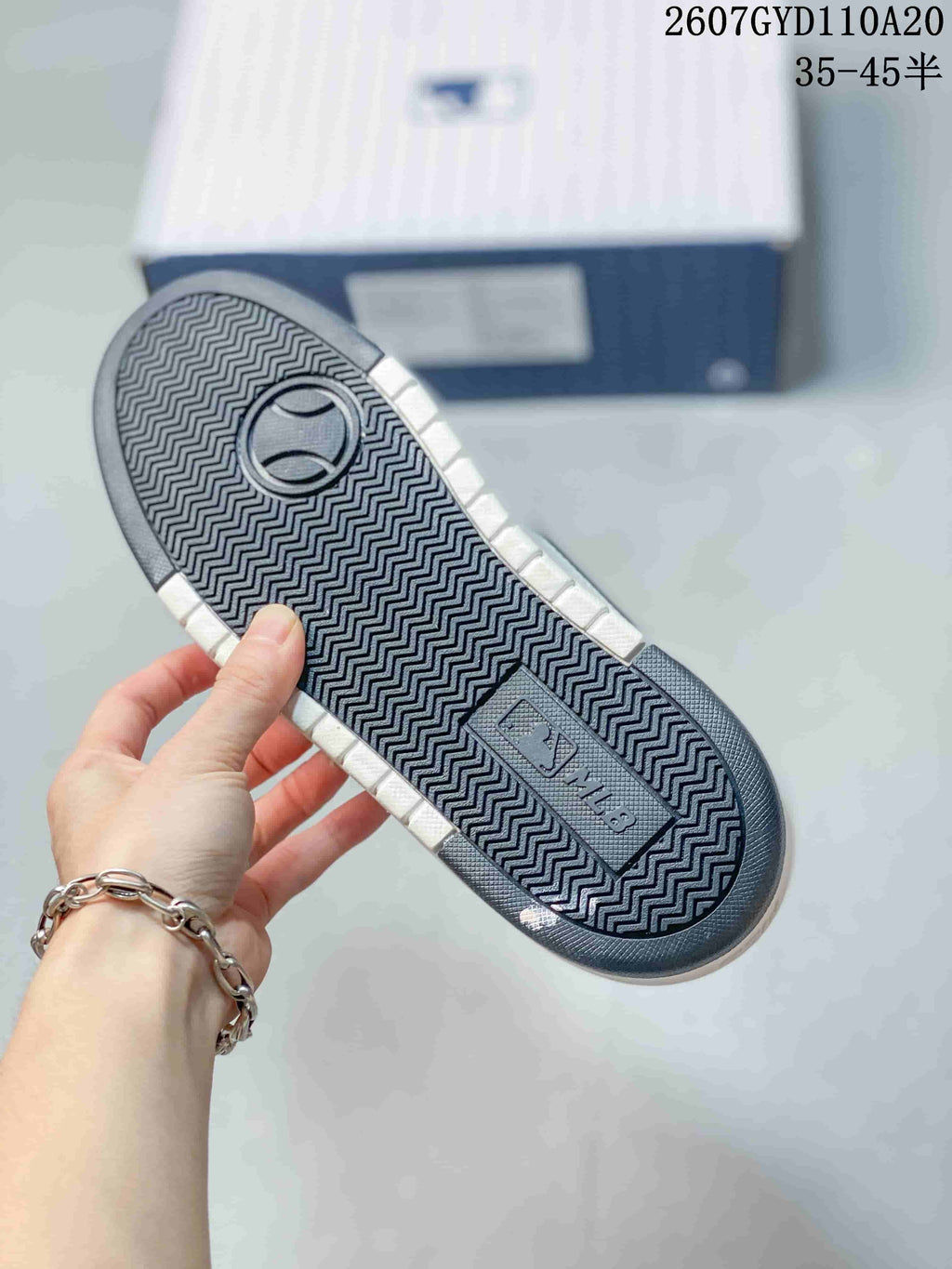 Close-up of the sneaker outsole showing a repeating zigzag tread pattern and MLB branding.