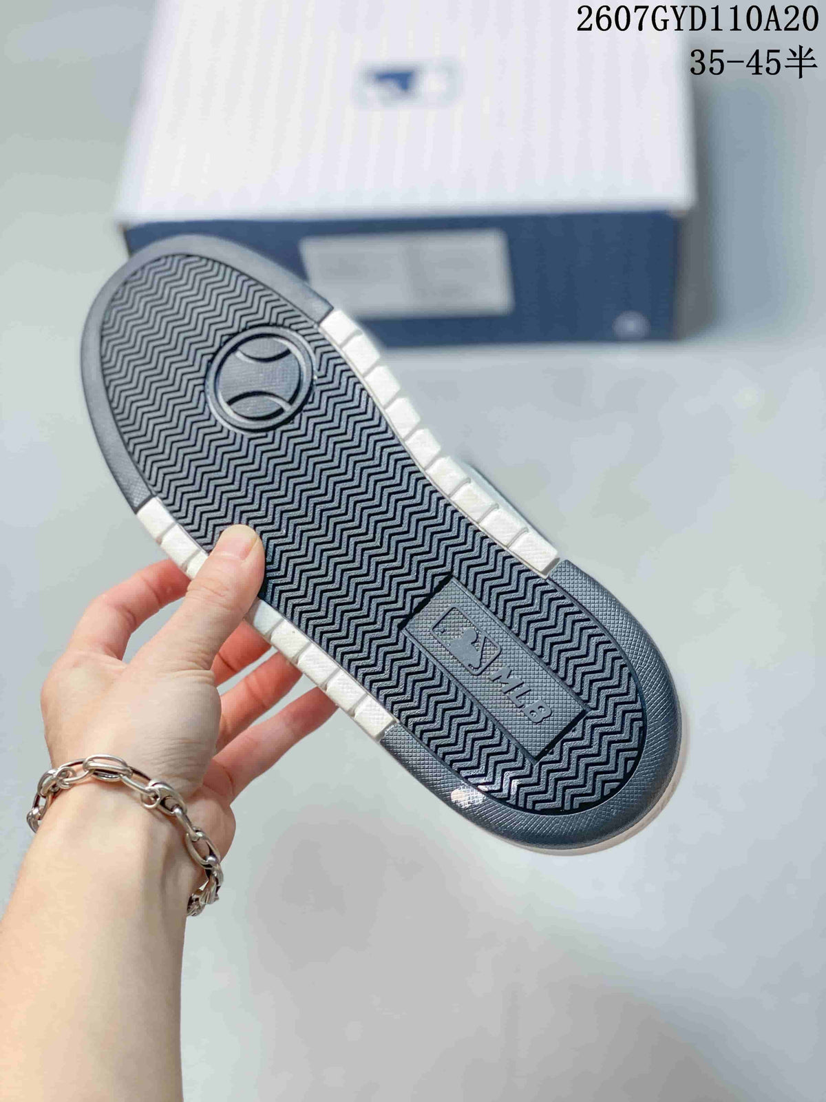 Close-up of the sneaker outsole showing a repeating zigzag tread pattern and MLB branding.