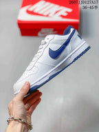Side profile showing the white upper, navy Swoosh detail and navy outsole.
