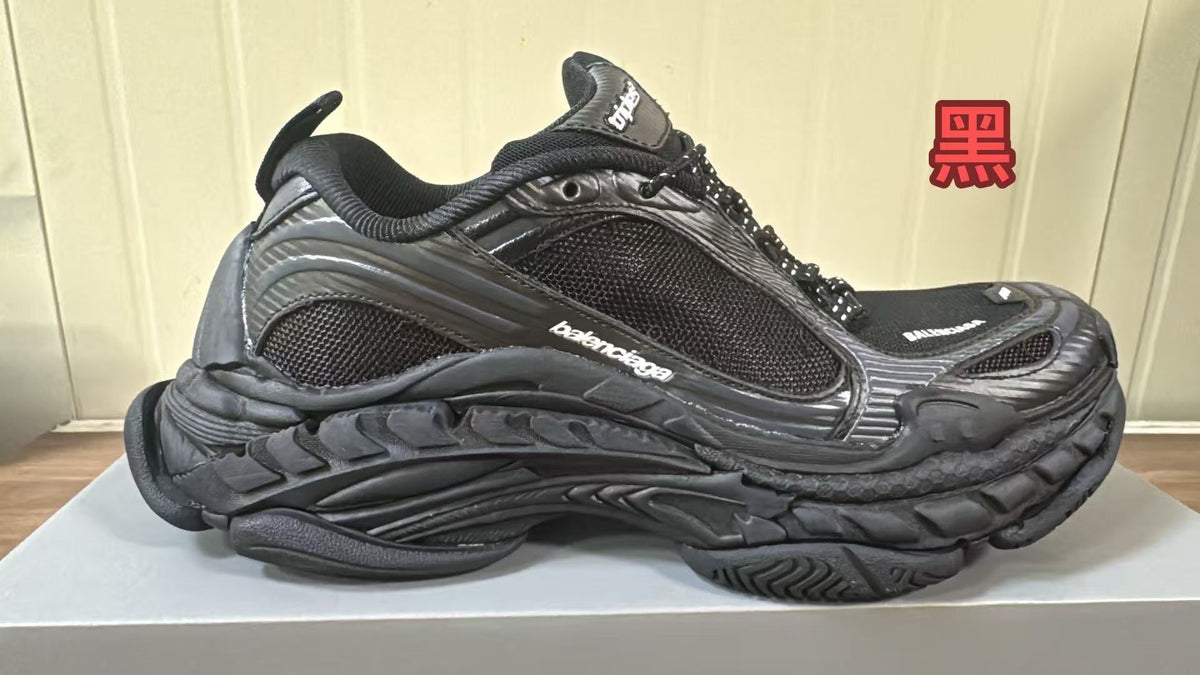 All-black chunky Balenciaga sneaker with mesh panels, tonal overlays and a sculpted layered sole.