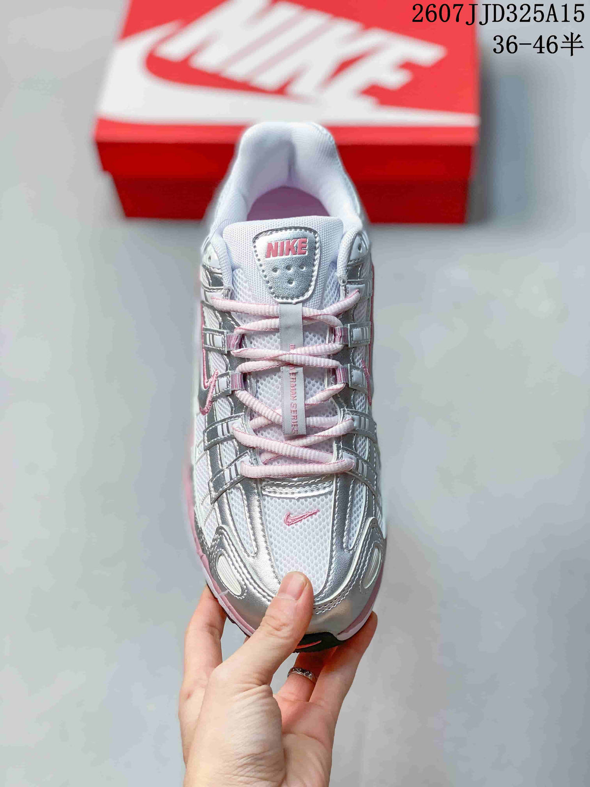 Top view of the sneaker showing the silver upper, pink laces and accents, mesh tongue, and Nike tongue label.