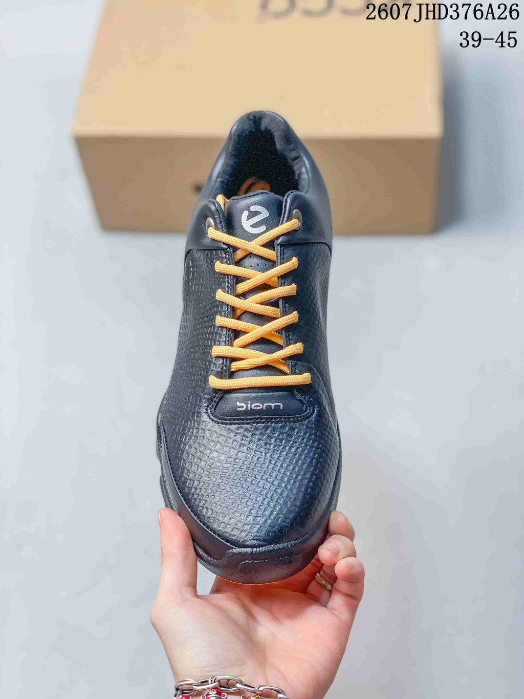 Top view of a dark ECCO BIOM sneaker with orange laces and BIOM branding on the tongue and lace panel.