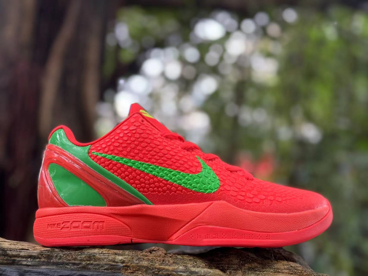 Side view showing the red textured upper and green detailing on a Nike Kobe 6 shoe
