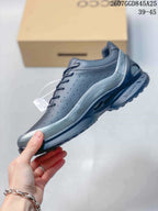 Side profile of the black low-top sneaker showing the perforated upper, silver-toned overlay, lace-up closure, and treaded sole.