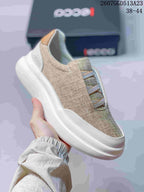 Side view of a beige ECCO slip-on sneaker showing the elastic cross straps, padded collar and thick white outsole.