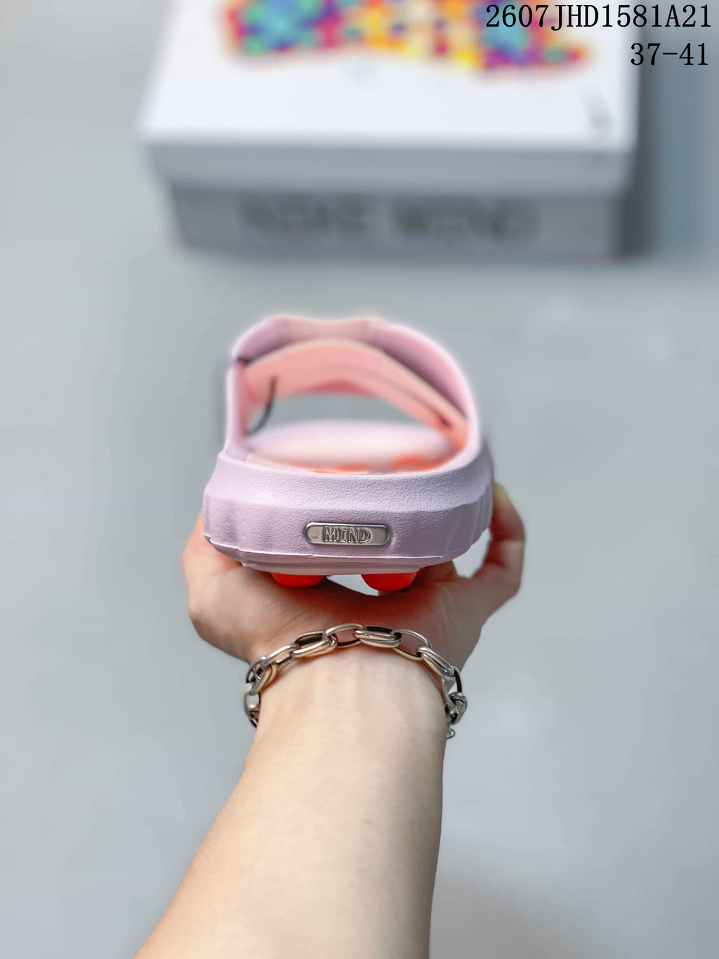 Rear view of the light pink mule slide showing the raised heel area and Mind branding.