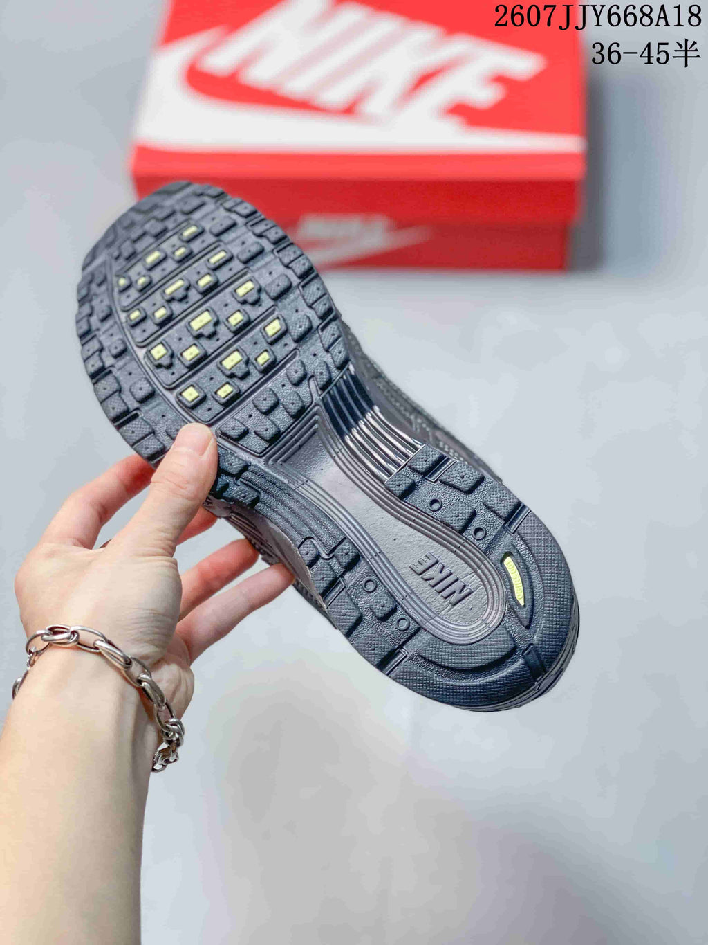 Close-up of the textured outsole showing segmented tread blocks and Nike branding.