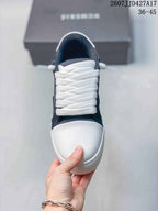 Top view of the sneaker showing the white laces, navy upper, and textured white toe panel.