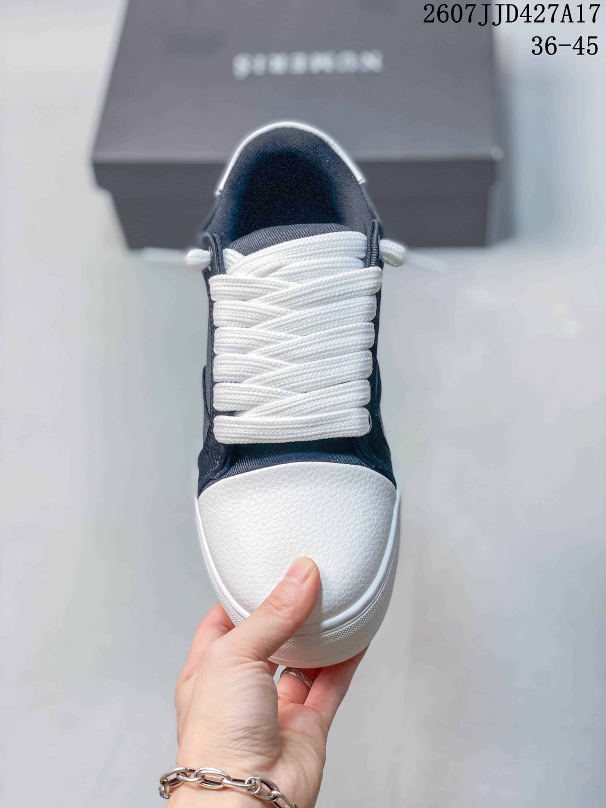 Top view of the sneaker showing the white laces, navy upper, and textured white toe panel.