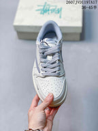 Top view showing the perforated white toe box, grey patterned laces, and padded collar.