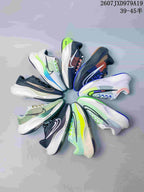 Several Nike Zoom Fly-style sneakers arranged in a circular display, showing assorted dark, white, green and multicolor designs.