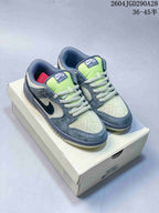 Pair of grey, cream, and lime Nike Dunk Low Pro SB sneakers displayed on a box