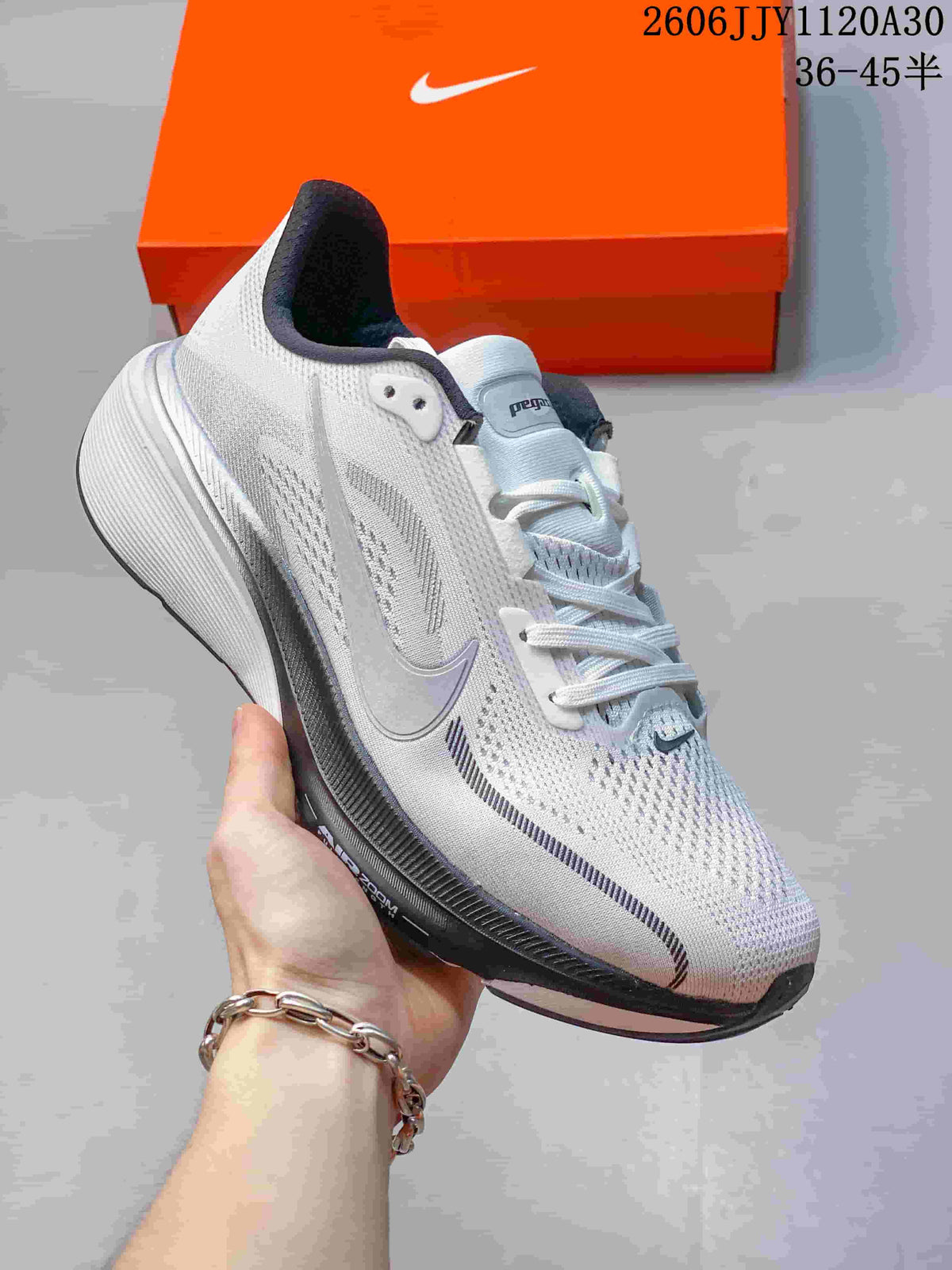 Angled side view of a white and gray Nike Pegasus 42 shoe