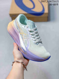 Light-colored ASICS Magic Speed 4 running shoe with pale blue and lavender accents, shown beside a shoe box.
