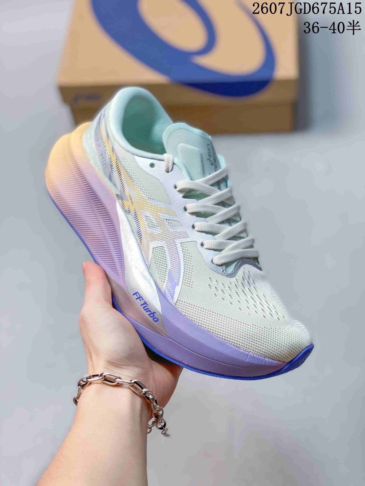 Light-colored ASICS Magic Speed 4 running shoe with pale blue and lavender accents, shown beside a shoe box.